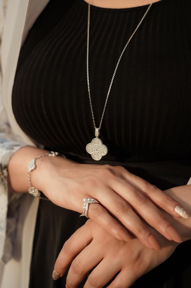 Client wearing a diamond clover pendant